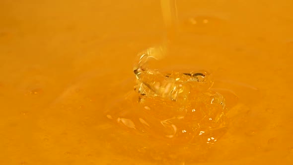 Pouring Fresh Honey Into Bowl