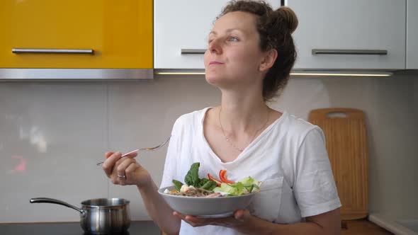 Young Woman Eating Healthy Delicious at Her Kitchen. Healthy Homemade Food.