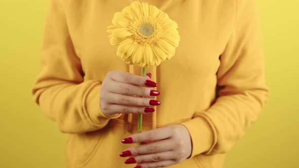 Body Part of Woman with Yellow Flower