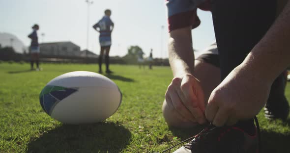 Young adult female rugby player on a rugby pitch