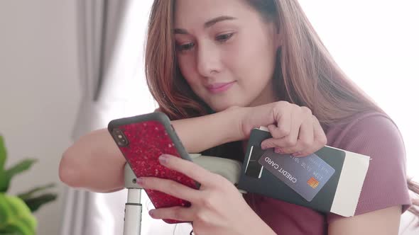 Woman happy selfie portrait with her passport and credit card before travel trip