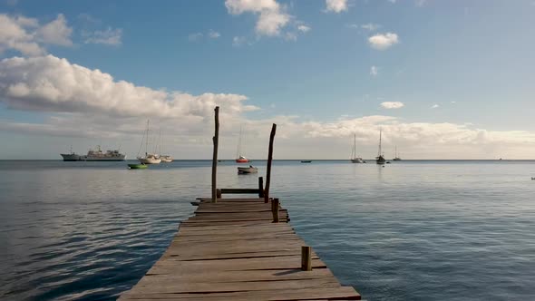 Aerial shot of an old wooden dock that survived a hurricane in Caribbean