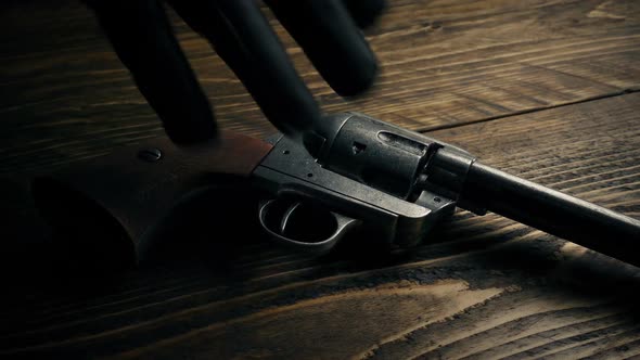 Cowboy Gun Picked By Gloved Hand alt