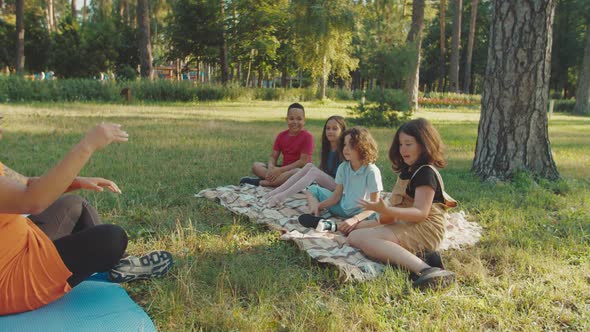 Teacher Throwing Ball to Children to Catch They Laughing and Relaxing