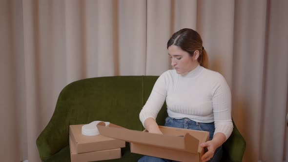 Seller Merchant Packing Products in Cardboard Boxes Prepares Parcels for Delivery to Customers Work