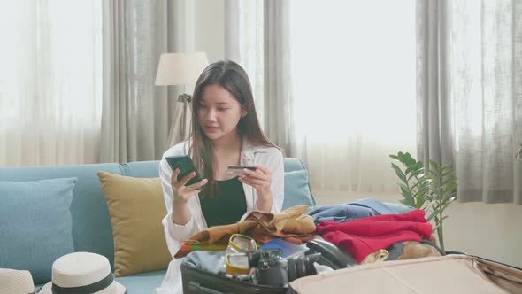 Asian Woman Booking Hotel On Smartphone With Credit Card Before Go To Travelling