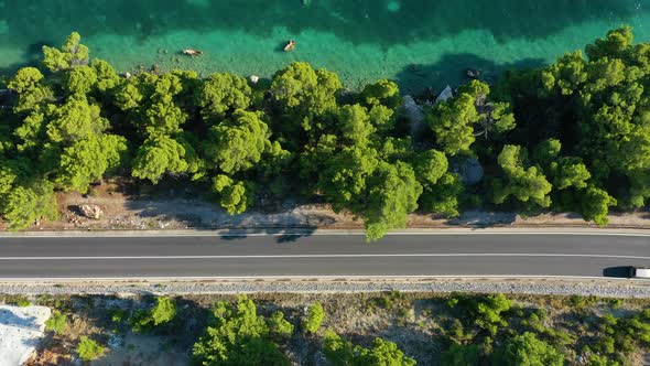 View of the road along the coast from the drone. Travel by car in summer time.