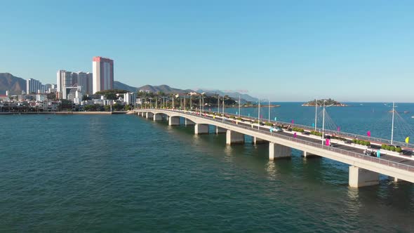 Shooting Aerial Unmanned Flight From Top View of the City Bridge with Cars and Motorbikes Against