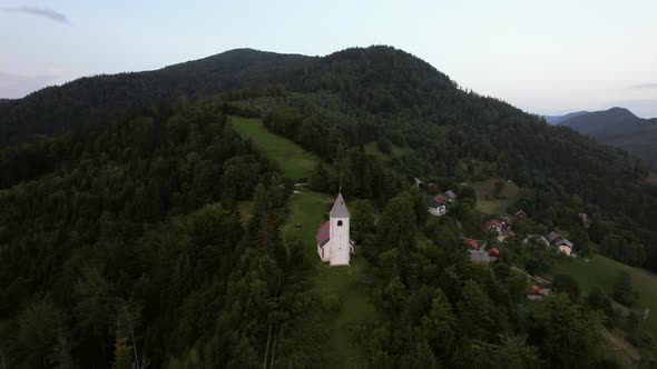This is an aerial video of a beautiful and lonely church in the Slovenian landscape, filmed during a