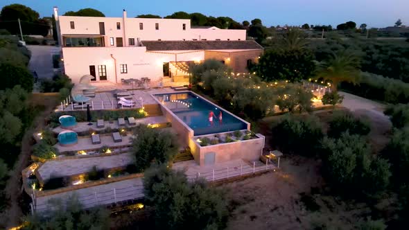 Couple on Vacation at Luxury Resort in Sicily During Sunset By the Infinity Pool in Sicilia Italy