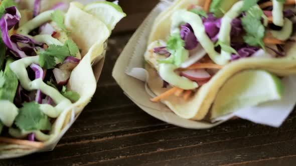 Street fish tacos with cod in recycled paper food tray.