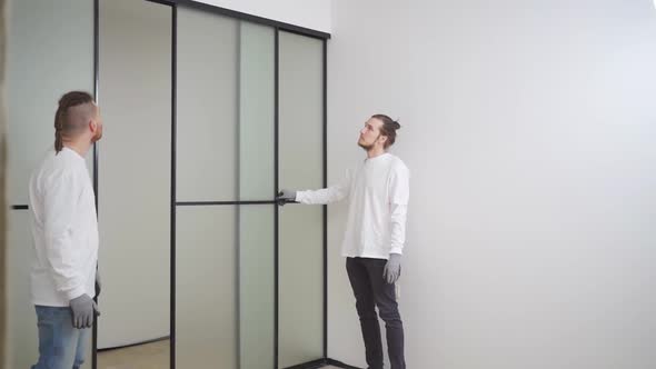 Masters Install Sliding Doors of Wardrobe Made of Metal and Glass