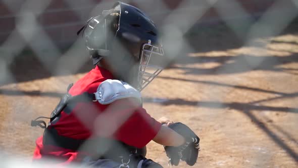 Close-up of a boy playing catcher for a little league baseball team.