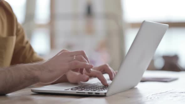 Hands Close up of Man Typing on Laptop