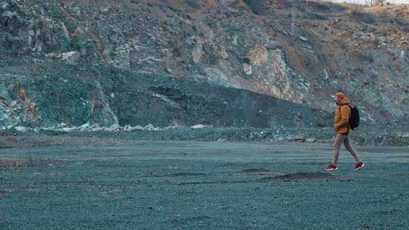 Man Photographer Walking in the Mountains the Background of Rocks