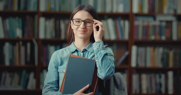 Portrait of Smiling Female Student in Library