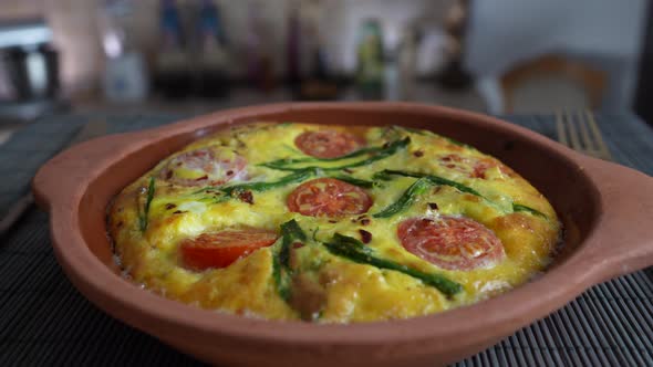 Vegetable frittata with egg, tomato, pepper, onion, cheese and green wild garlic