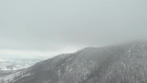 Snowing on top of the mountain Veliki Krsh 4K aerial video