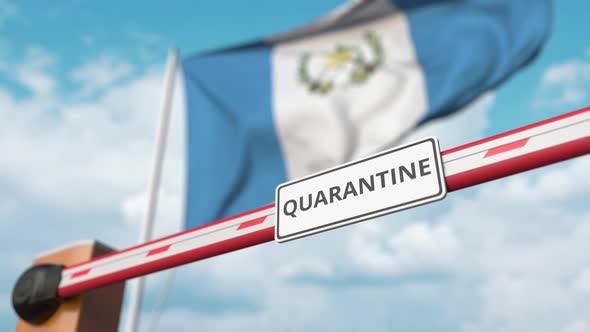 Barrier Gate with QUARANTINE Sign Being Open at Flag of Guatemala