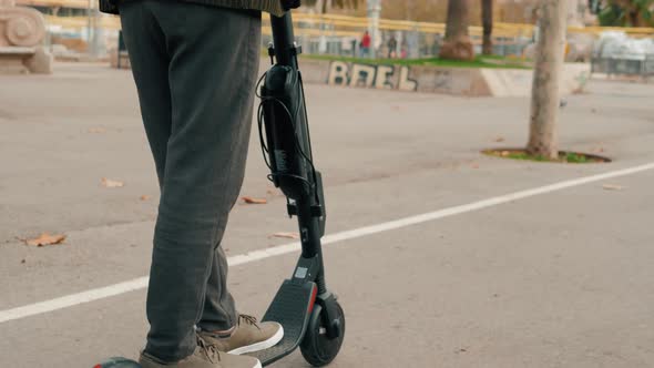 E-scooter Rider, Man Ride Sharing or Rent Personal Eco Transportation. Man Hipster Riding an