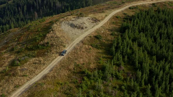 Drone Mountain Roadtrip Car Going to Rocky Peak Green Trees Growing Scene