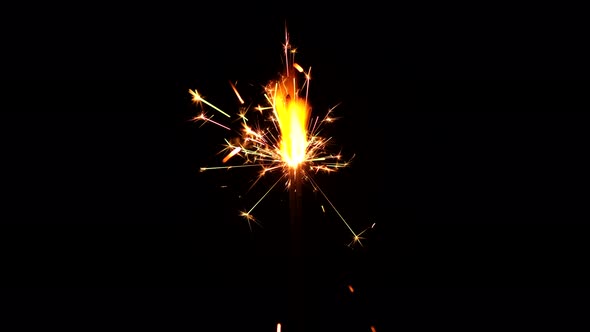 Burning sparkler close up on black background. Burning New Year sparklers