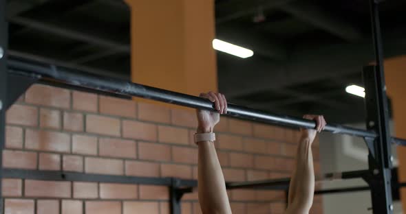 Young Woman Performs Pull-ups on the Horizontal Bar, Crossfit Training Day in the Gym, Strength Body