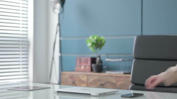 Businesswoman Coming Back Opening Laptop in Office