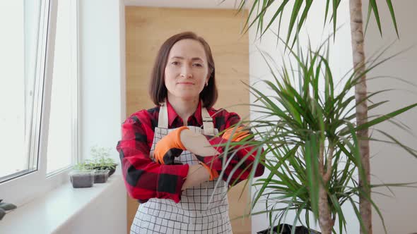 Portrait of a Female Gardener Next to a Dracaena