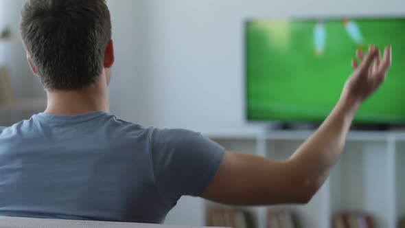 Nervous Man Watching Game on Television, Disappointed With Result, Back View