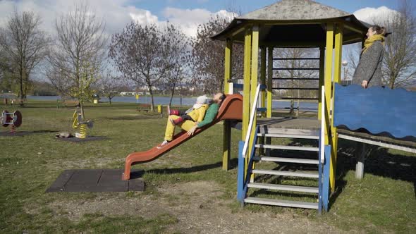 Father playing with infant son in public playground, Zagreb, Croatia.