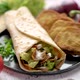 Traditional Turkish Doner Kebab in a Wrap Served with Fresh Ingredients and Deep Fried Dumplings - VideoHive Item for Sale
