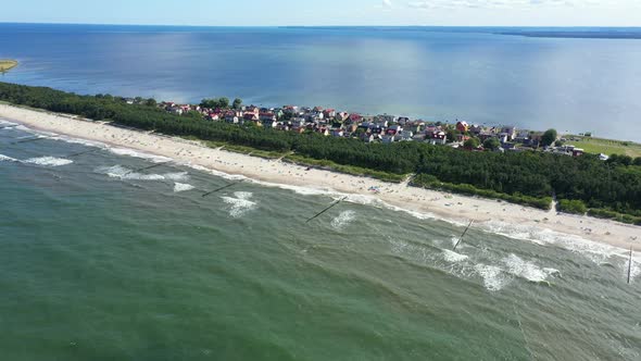 Beach in beautiful city Chalupy resort in Poland. Aerial video. Baltic Sea.Waves coming in.