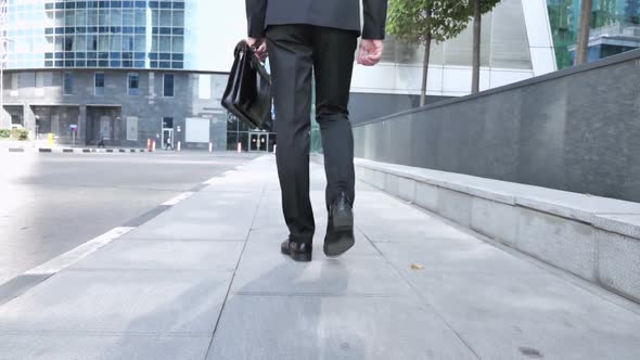 Back View of Walking Legs of Businessman in Suit