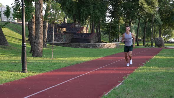 Athletic Muscular Man Runner Jogging Outdoor in Park Sport