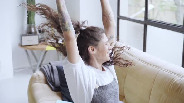 Joyful Young Girl Winner Jumps Dancing at Home Celebrating Mobile Victory Concept