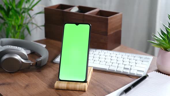Smartphone in a Holder on Office Table