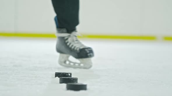 Hockey Player Practicing Shooting Pucks