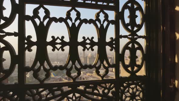 View of Cairo City and Mosque of Sultan Hassan Through Iron Bars of Window