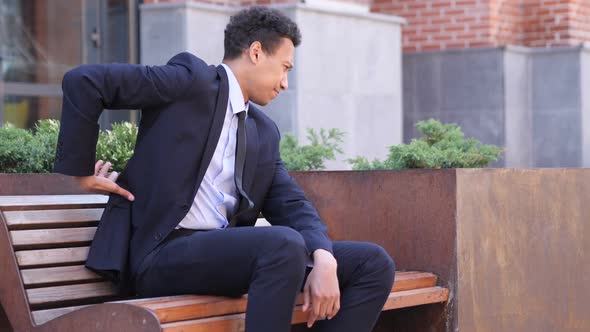 Tired African Businessman Relaxing Back Pain Outside Office