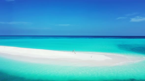 Luxury drone copy space shot of a white paradise beach and blue sea background in 4K