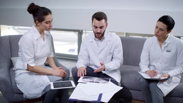 Male Dentist Conversing with Female Colleagues