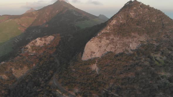 Aerial forward tilt up reveal over mountains near Pico do Facho, Portugal