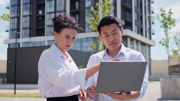 Adult Beautiful Business Woman and Asian Man Negotiating Discussing Project