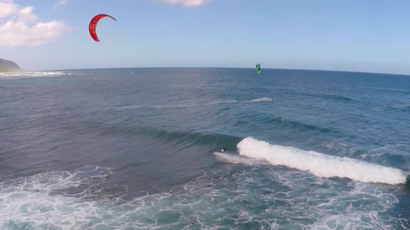 Aerial view of a man kitesurfing in Hawaii.