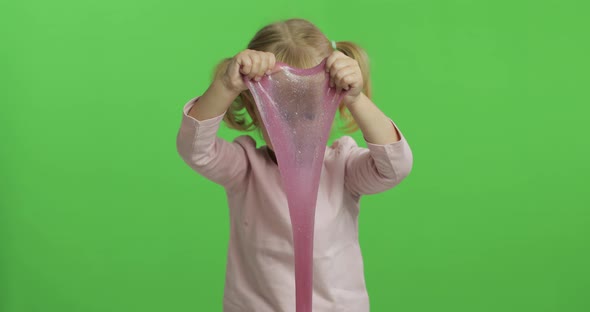 Kid Playing with Hand Made Toy Slime. Child Having Fun Making Pink Slime