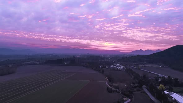 Hyperlapse drone footage of the sky, pink tone, highways cars and hills