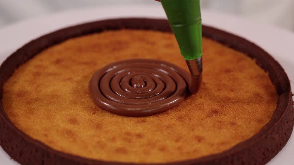 Putting Chocolate Filler Spiral on Traditional Tart on Stand