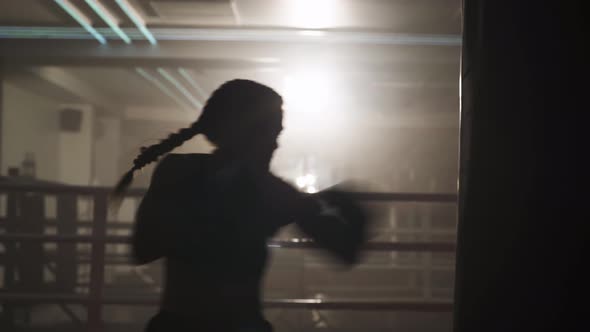 Boxing, Woman Fighter Trains His Punches, Beats a Punching Bag, Training in the Boxing Gym, Strength