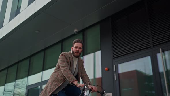 Young Hipster Businessman Going to Work on Bike